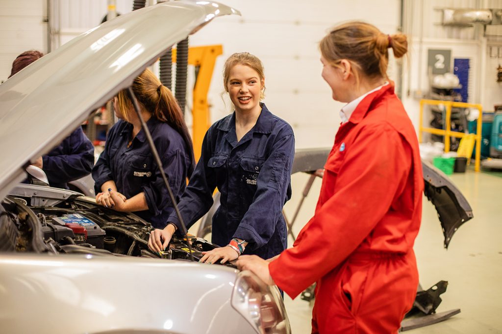 Group of Automotive students looking at an engine